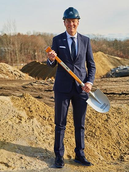 UNE President James Herbert poses with a shovel at the groundbreaking 